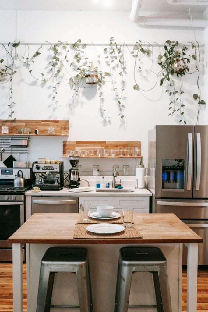 pexels-photo-5825699-5825699 Stylish kitchen interior featuring modern appliances and hanging greenery for a fresh look.